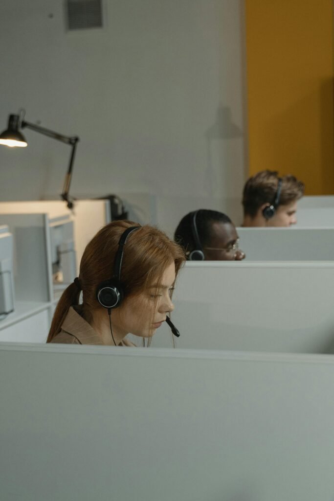 pexels-photo-5453828-5453828 A Woman with Headset Inside a Gray Cubicle